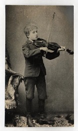 A black and white photo of a young Gustav Holst playing the violin