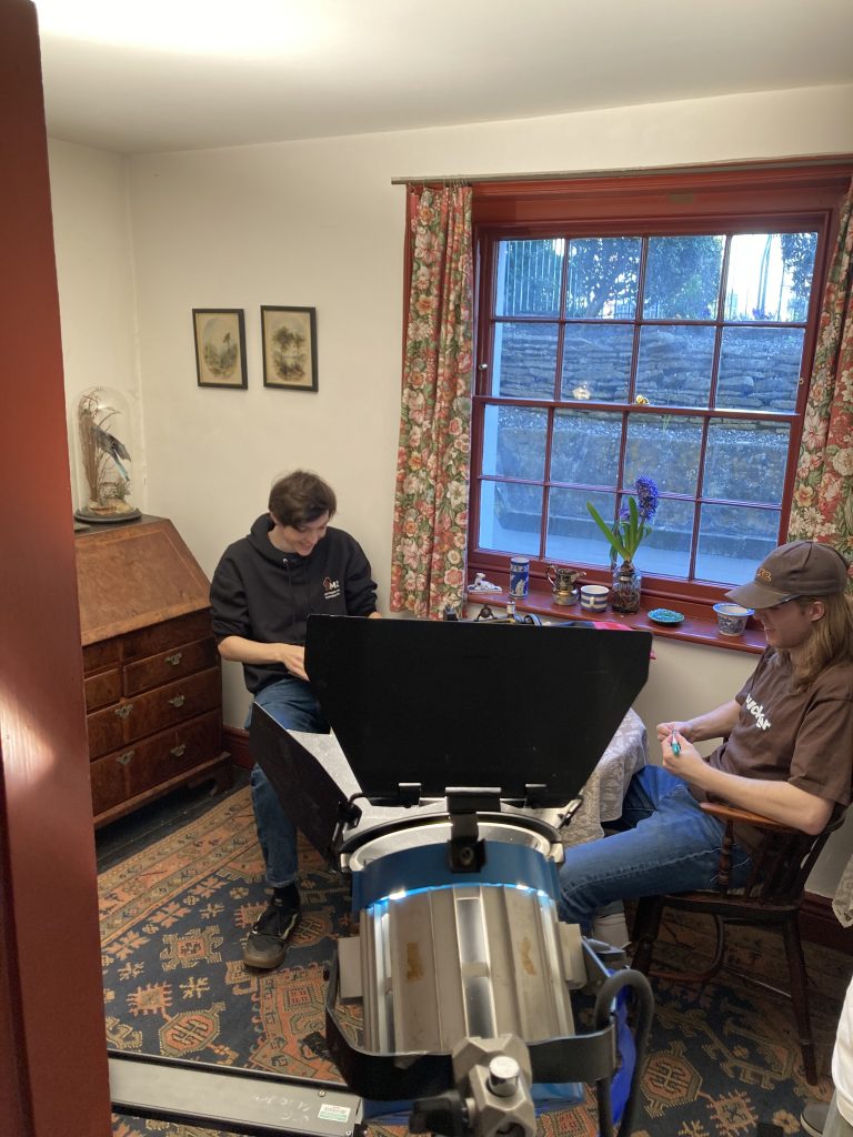 Two male Higher Education students sit in the Maid's Sitting Room
